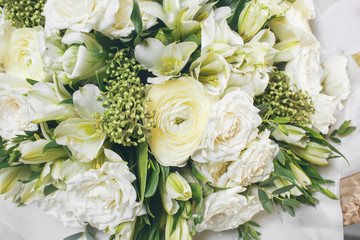 rich bouquet flowers of different colors mixed in woman hand .