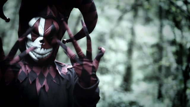 4k Halloween Shot of a Child in Joker Costume Showing Creepy Fingers