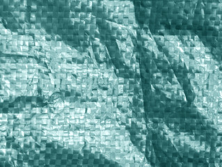 Cyan plastic bag surface with blur effect.
