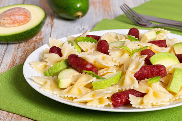 farfalle Pasta warm salad with avocado slices and smoked sausage