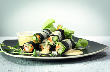 Salad roll in black dish