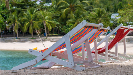 Appealing Beach Chairs on Sand. Palm Trees and Ocean in Background. Haad Salat. Koh Pangang, Thailand