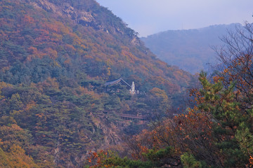 Obraz premium Mountain Buddhist temple and blue sky / Mountain Buddhist temple located below and blue sky in Korea 