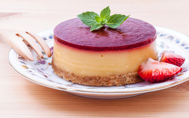 Strawberry cheesecake with fresh mint leaves on wooden backgroun