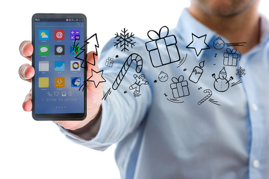 Hand of a man holding smartphone with christmas icons all around