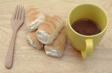 Hot Coffee and Cream Bread on wooden background