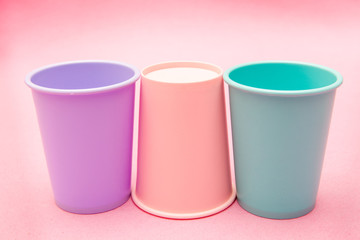 colorful mug cups on pink backgrounds