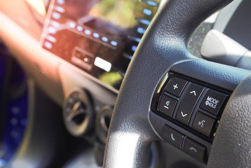 Control buttons on steering wheel in a modern car. soft focus.