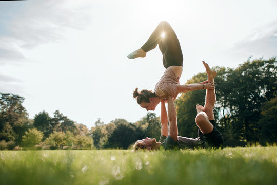 Couple Doing Acro Yoga In Pair