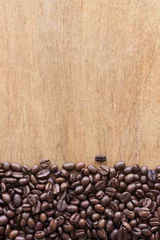 Fotobehang coffee beans on grain wooden table background  © memorystockphoto
