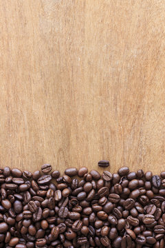 coffee beans on grain wooden table background 