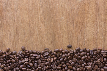 coffee beans on grain wooden table background 