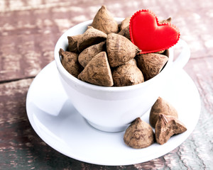 White cup with candy and heart  Valentines day concept