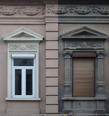 Fototapeta na wymiar Old and new window on the same wall