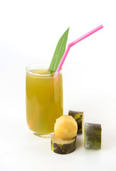 Fresh sugar cane juice in glass on white background