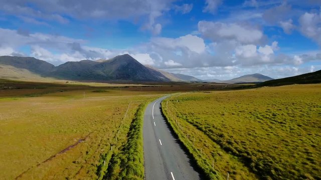 The long road and the mountain view on the back in Connemara National Park in Ireland where it is one of the tourist spots in Ireland