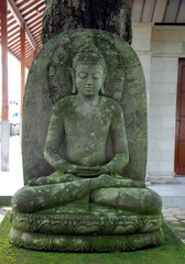 Ancient Buddha in Borobudur temple complex. Java Island, Indonesia 