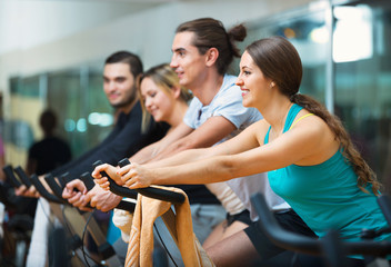 Group working out of cycling in fitness club