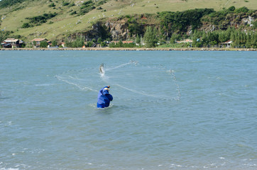 Fisherman on the Brazilian coast throwing net in the sea