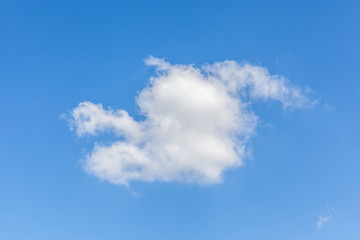 Naklejka na ściany i meble White fluffy clouds over the blue sky background.