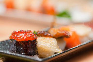 Japanese sushi. Roll made of Smoked fish and roe.