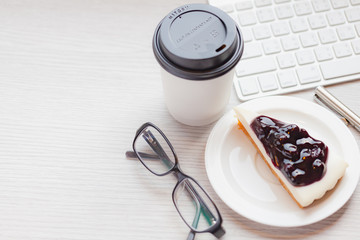 Disposable coffee cup with blueberry chess pie.