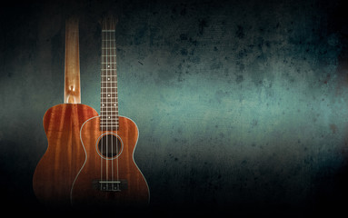 Fototapeta na wymiar Part of a orange acoustic guitar on black background.