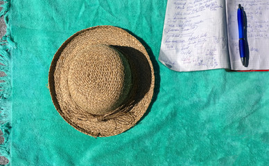 Sunbathing and working with pen and notebook outdoors