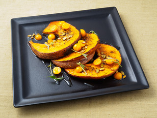 Baked pumpkin with winter cherry and rosemary.