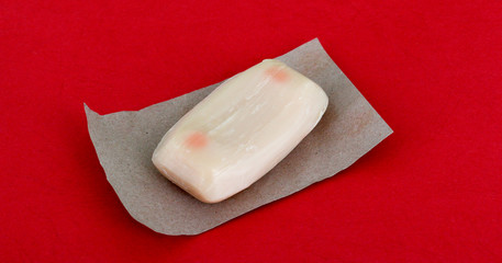 unused soap with cocoa aroma on red bakground
