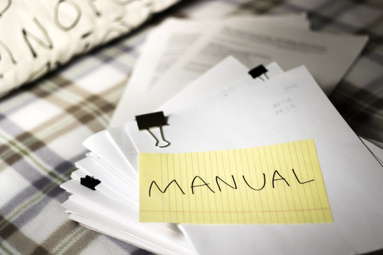 Manual; Stack of Documents. Working or Studying at Bedroom.
