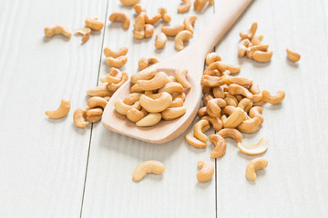 Cashew nuts on a wooden ladle