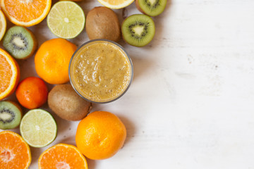 Smoothie rich in vitamin C made with oranges, lemons, limes, clementines, kiwis, top view, selective focus
