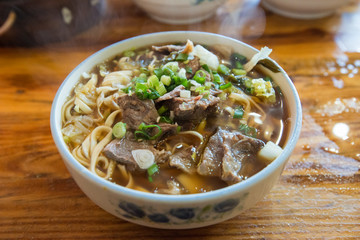 Chinese yellow noodle with yummy soup noodle seasoned with soy sauce, green onion, beef broth and sesame oil. The favorite Chinese breakfast foods.