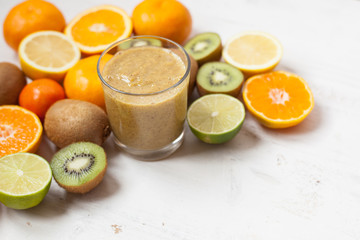 Smoothie rich in vitamin C made with oranges, lemons, limes, clementines, kiwis, copy space for text, selective focus