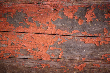 Old red ocher paint on wooden boards
