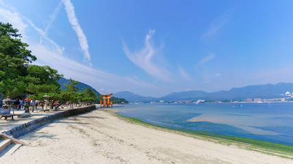 Scenery of sea coast on Miyajima Island viewing the famous orange floating Japanese shinto gate...