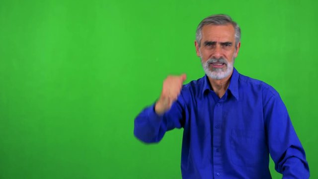 old senior man is angry (protest) - green screen - studio