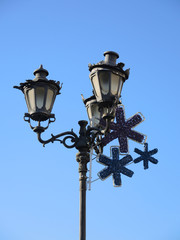 Fototapeta na wymiar Christmas street decoration against blue sky