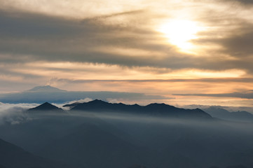 Silhouettes of mountains and Etna, clouds at sunset
