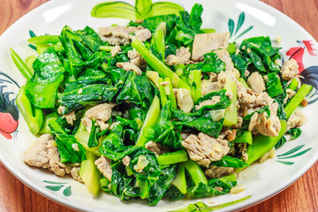 Thai food fried kale with  pork on wood