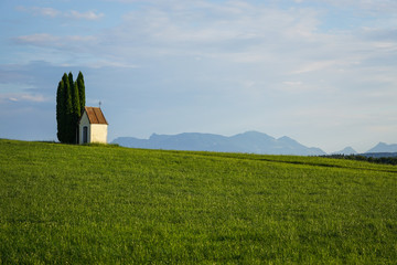 green meadow with little church 
