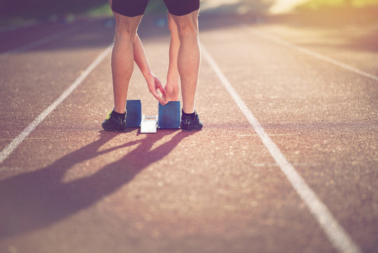 Close-up Of Feet Of An Athlete On A Starting Block About To Run