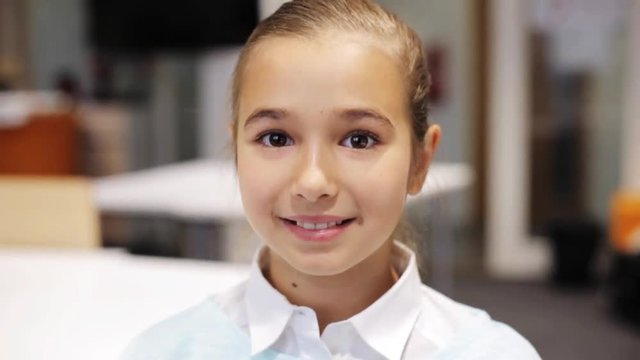 happy smiling beautiful preteen girl at school