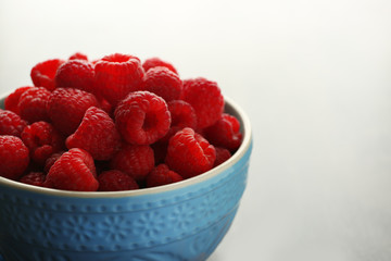 Fototapeta na wymiar Fresh raspberries in cup, closeup