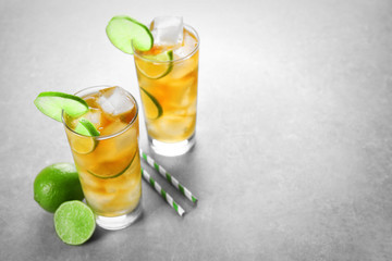 Glasses of iced tea with lime slices on table