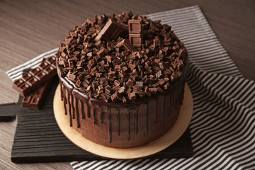 Tasty chocolate cake on cutting board, closeup