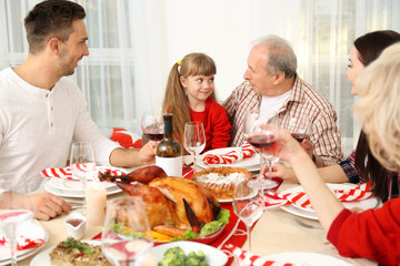 Obraz na płótnie Canvas Happy family having Thanksgiving dinner in living room