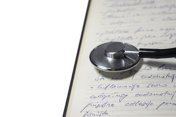 Stethoscope on  sheet of doctor's notebook 