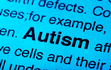Newspaper article with detailed word AUTISM, closeup